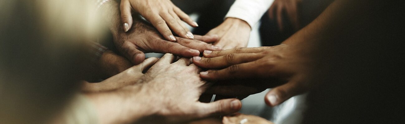 Closeup of diverse people joining their hands